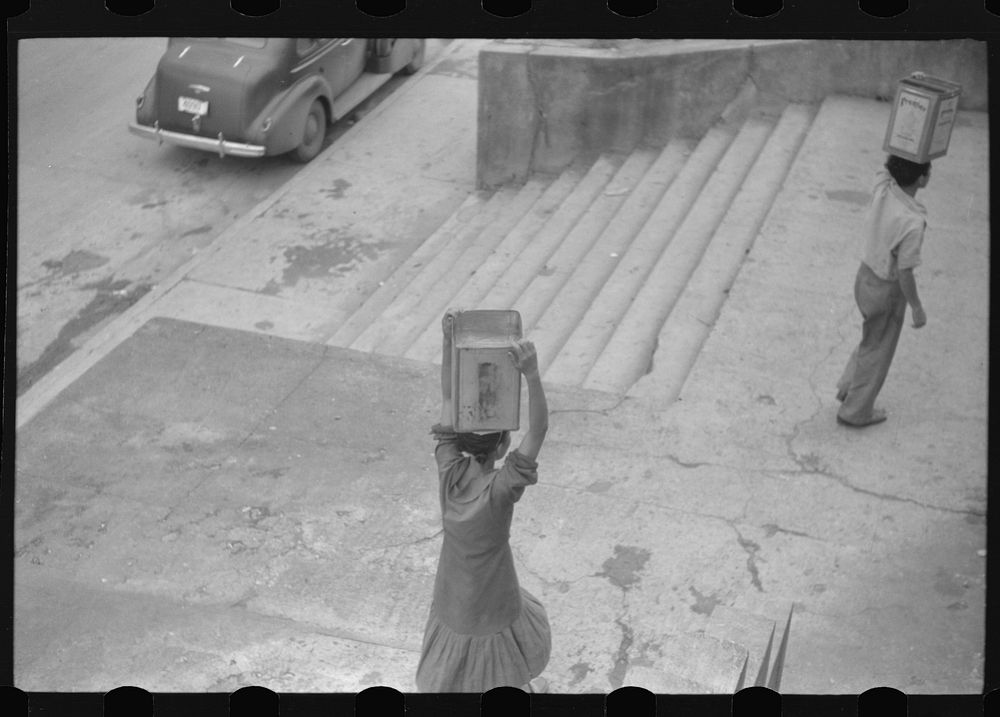[Untitled photo, possibly related to: San Juan, Puerto Rico. People carrying water home because of the failure of the water…