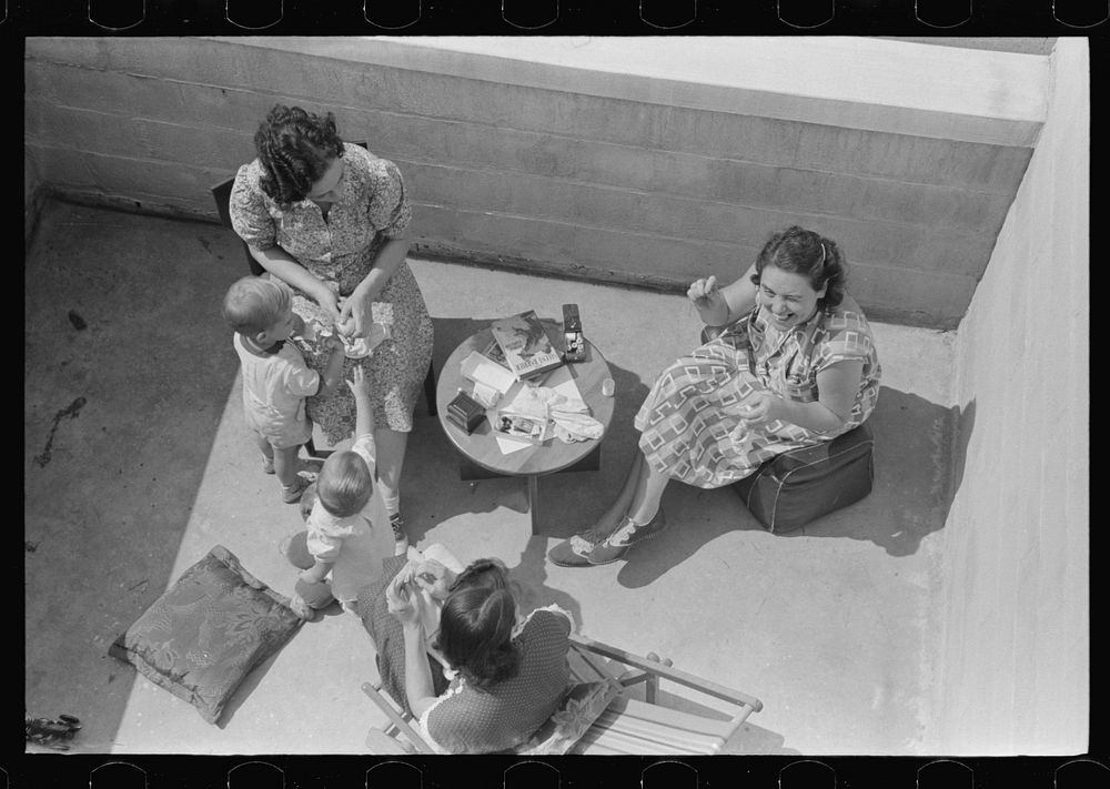 [Untitled photo, possibly related to: Family on terrace in Greenbelt, Maryland]. Sourced from the Library of Congress.