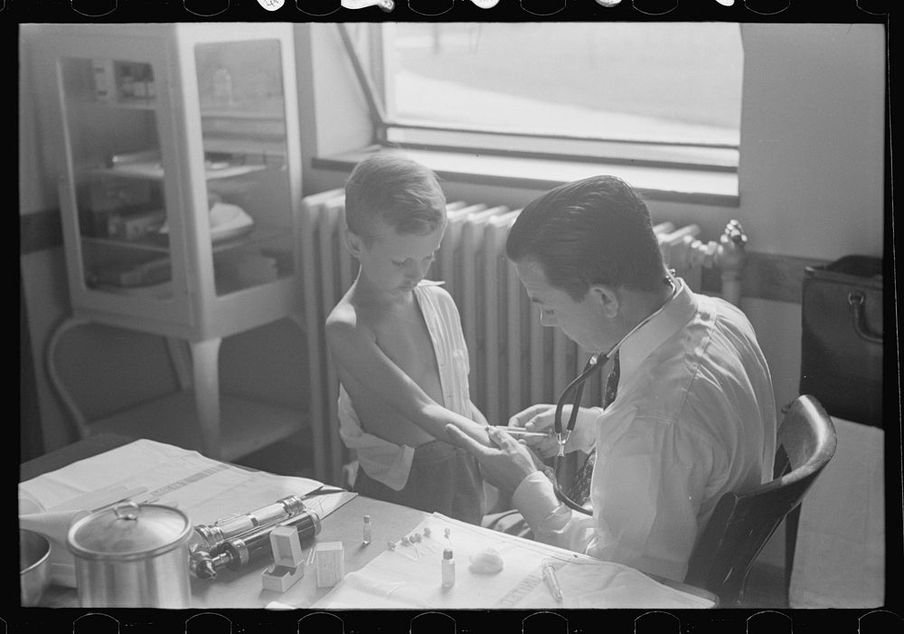 [Untitled photo, possibly related to: Doctor examining child at Greenbelt in preschool clinic, Maryland] by Marion Post…
