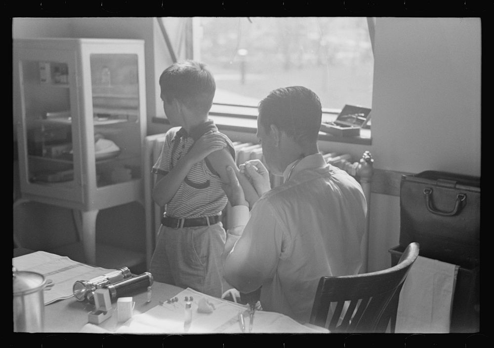 [Untitled photo, possibly related to: Doctor examining child at Greenbelt in preschool clinic, Maryland] by Marion Post…