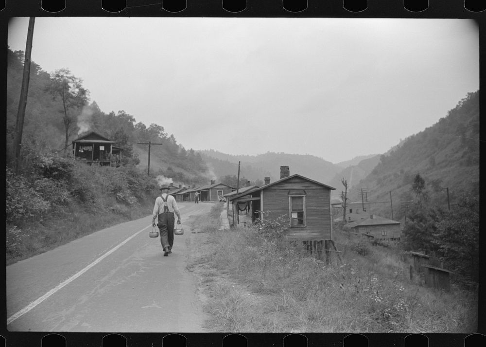 Carrying water to one of the houses in abandoned mining community, Marine, West Virginia. Sourced from the Library of…