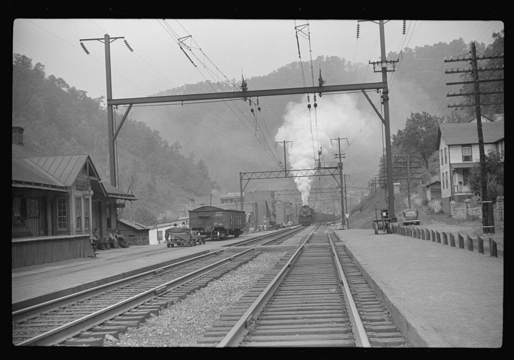 Coal train going through center of mining town. Davey, West Virginia. Sourced from the Library of Congress.
