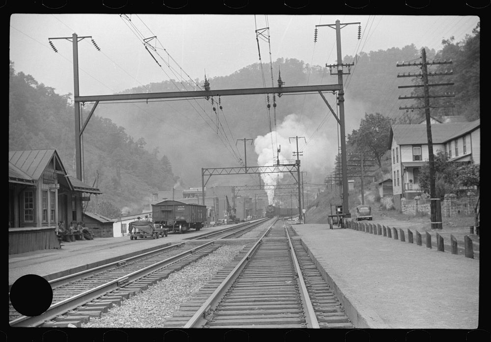 [Untitled photo, possibly related to: Coal train going through center of mining town. Davey, West Virginia]. Sourced from…