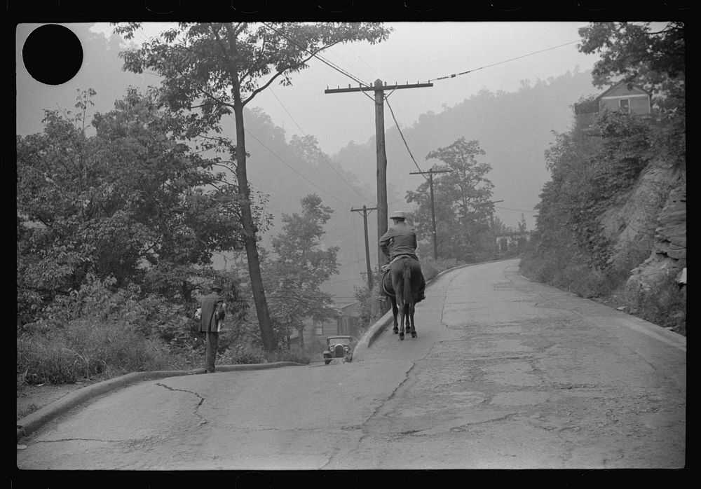 [Untitled photo, possibly related to: Old miner on donkey, still quite a common means of transportation, in county road near…