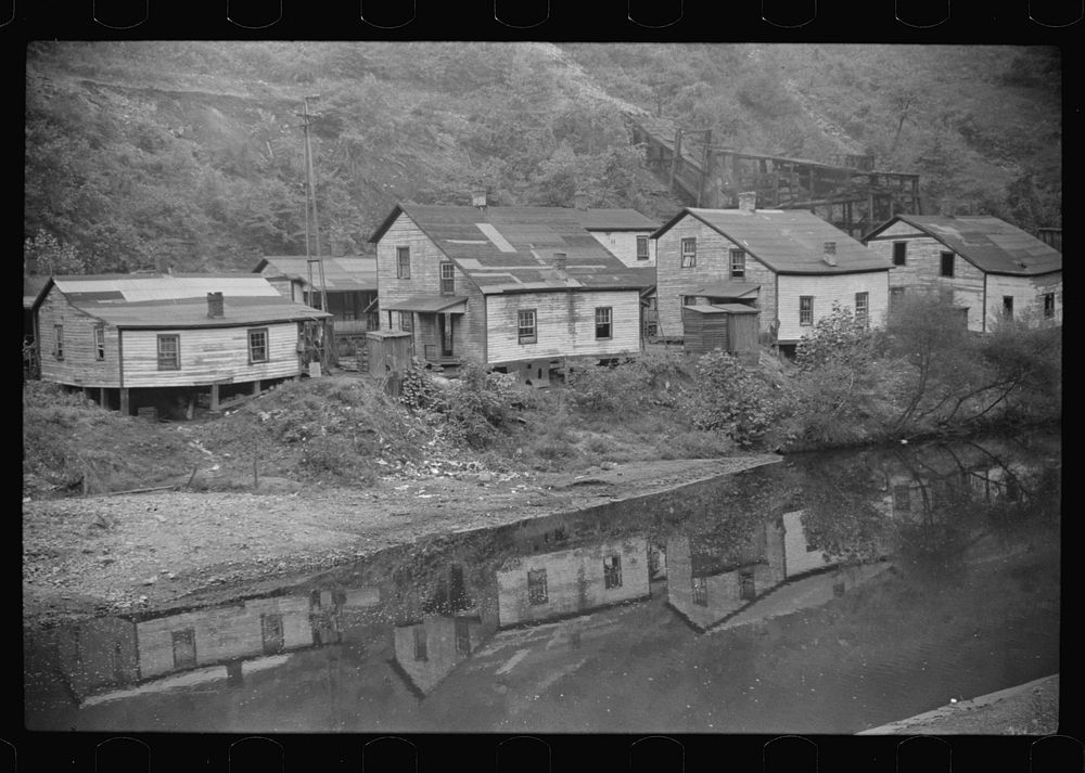 Houses in abandoned mining town with remains of coal tipple at right, Mohegan, West Virginia. Sourced from the Library of…