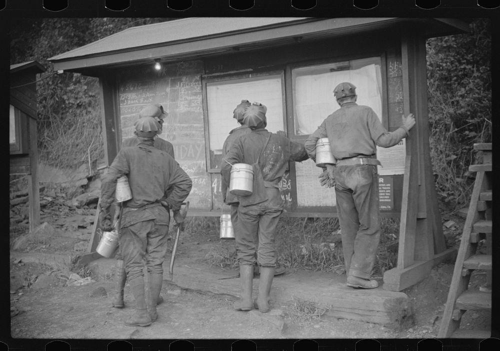 [Untitled photo, possibly related to: Miners looking at daily reports, checking the number of tons of slate and coal they…