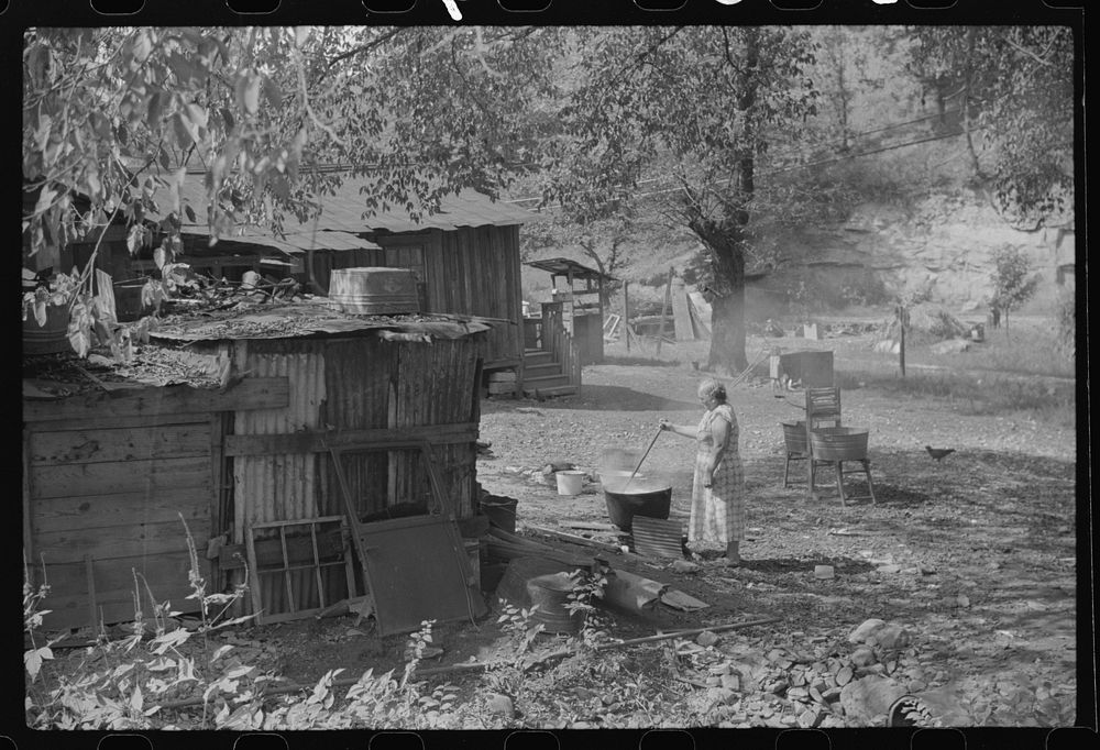 Old and sick, mine foreman's wife does washings in front yard. South Charleston, West Virginia. Sourced from the Library of…