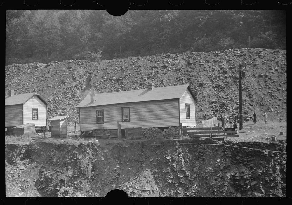 [Untitled photo, possibly related to: Coal miners' homes by slate and slag heap, Caples, West Virginia]. Sourced from the…