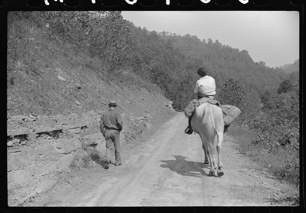 Miner and wife taking home provisions bought at company store, Caples, West Virginia. Sourced from the Library of Congress.