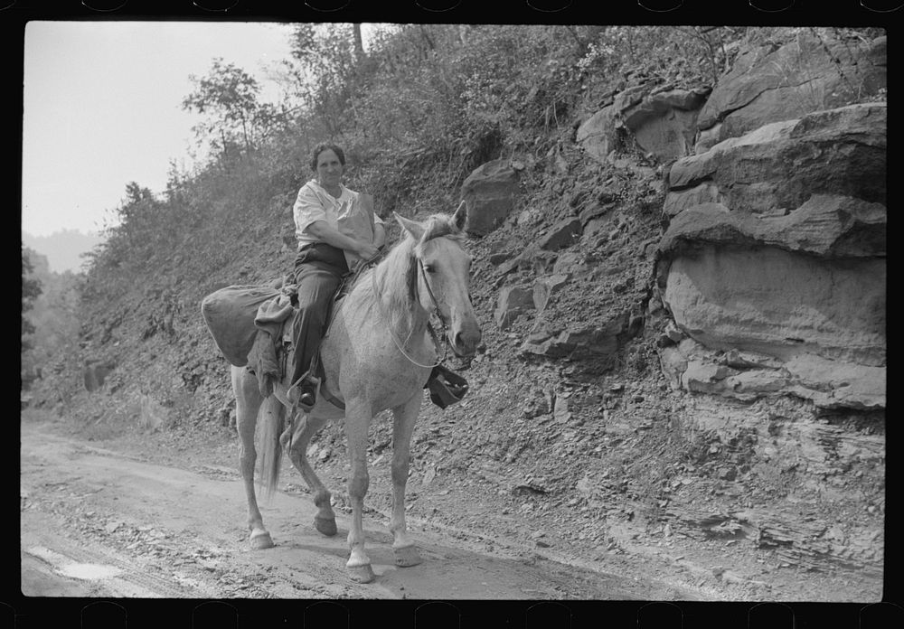 Coal miner's wife bringing groceries from company store, Caples, West Virginia. Sourced from the Library of Congress.