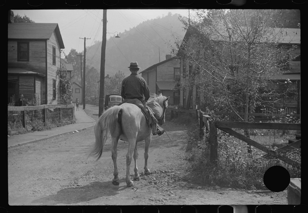 [Untitled photo, possibly related to: Miner taking home provisions, Caples, West Virginia]. Sourced from the Library of…