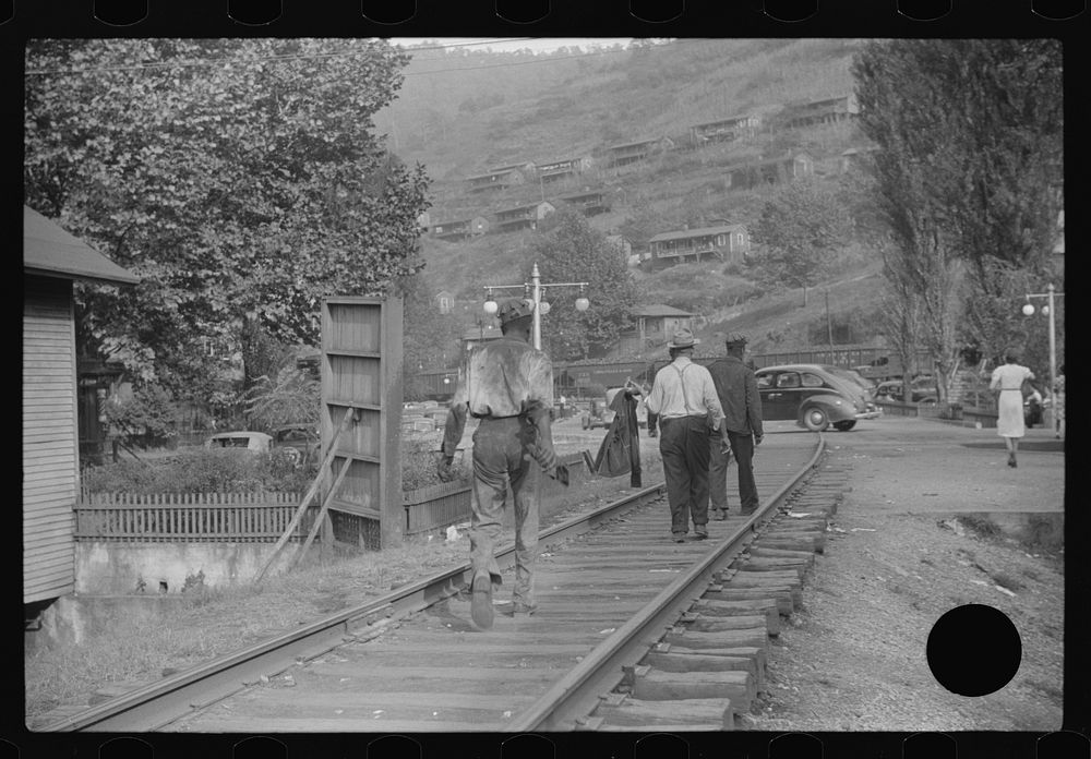 [Untitled photo, possibly related to: Coal miners returning to and from work and children going from school along tracks…
