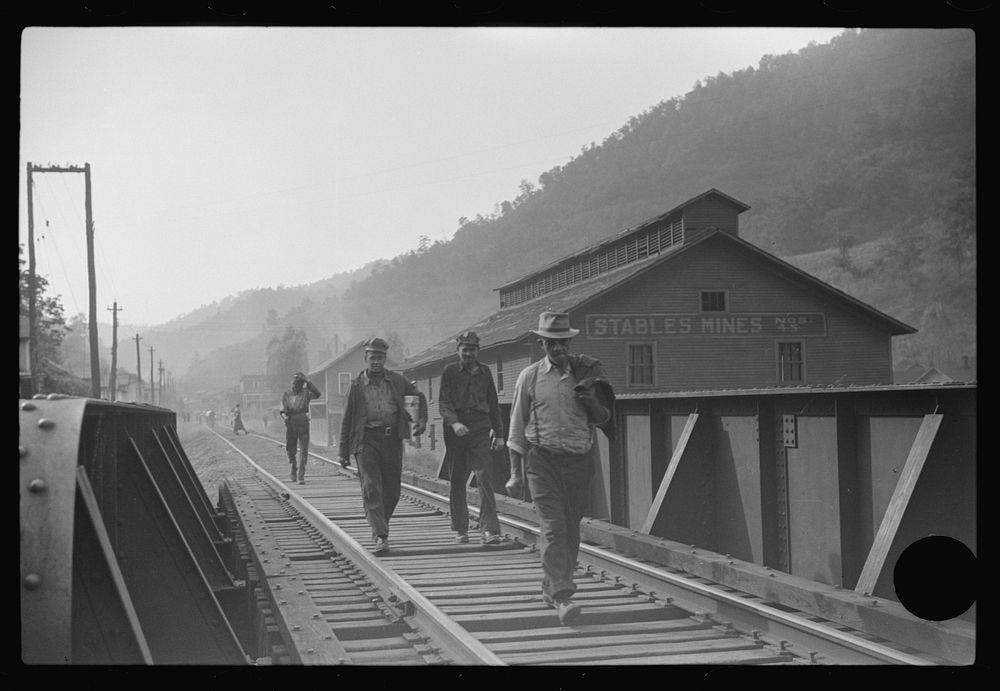 [Untitled photo, possibly related to: Coal miners returning to and from work and children going from school along tracks…