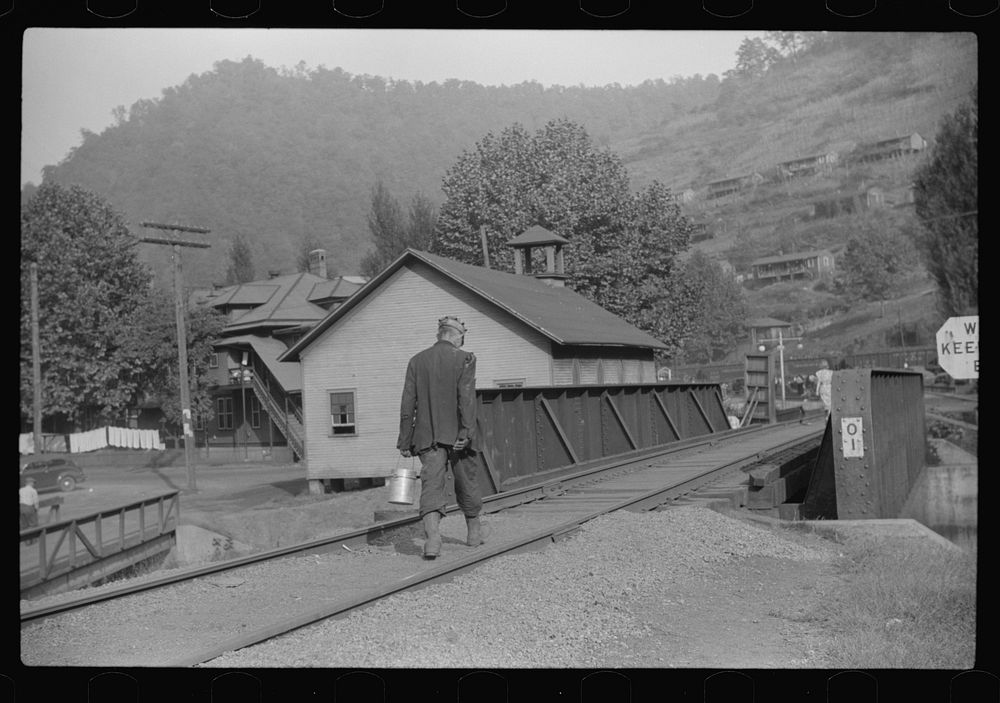 [Untitled photo, possibly related to: Coal miner going home with friend after work. Many miners are lame. Omar, West…