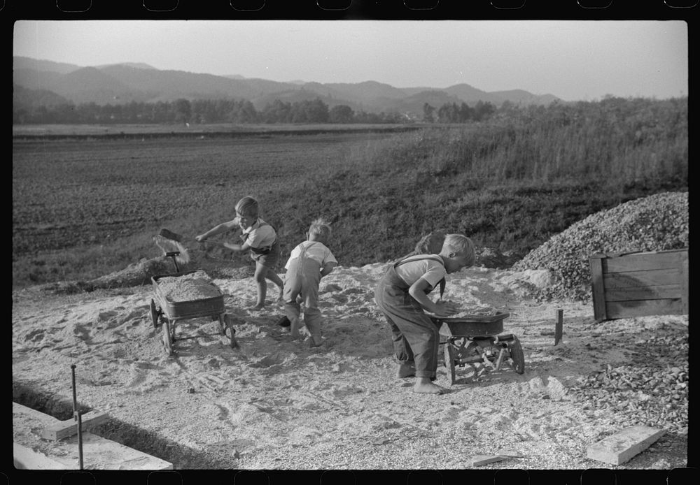 Homesteaders' children playing in pile of sand, Tygart Valley, West Virginia. Sourced from the Library of Congress.