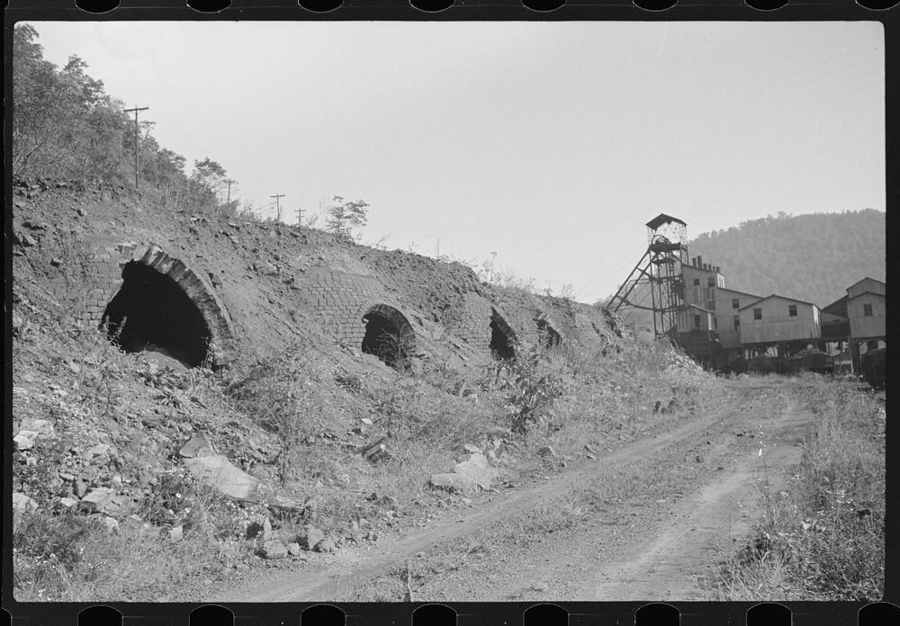 Old abandoned coke ovens with mine tipple in background, Maitland, West Virginia. Sourced from the Library of Congress.