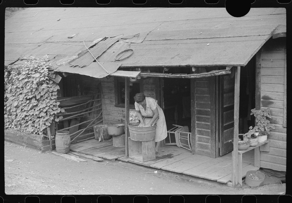 [Untitled photo, possibly related to: Coal miner's wife washing clothes on front porch, Chaplin, West Virginia]. Sourced…