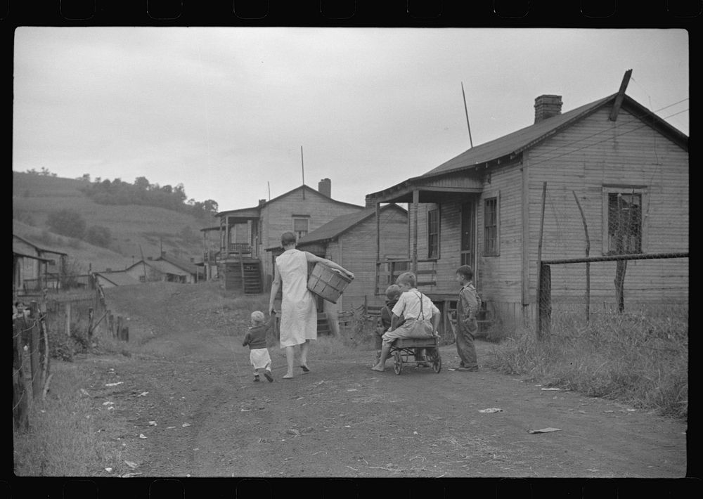 [Untitled photo, possibly related to: Coal miner's wife and child on main road in community.  Chaplin, West Virginia] by…