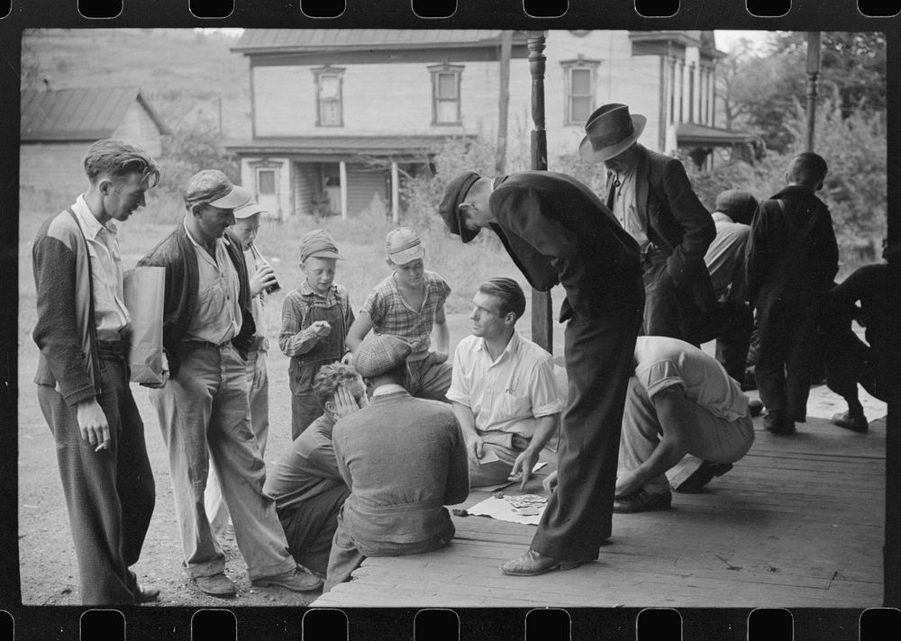 Coal miners card gambling Saturday afternoon on porch of company store, Chaplin, West Virginia. Sourced from the Library of…
