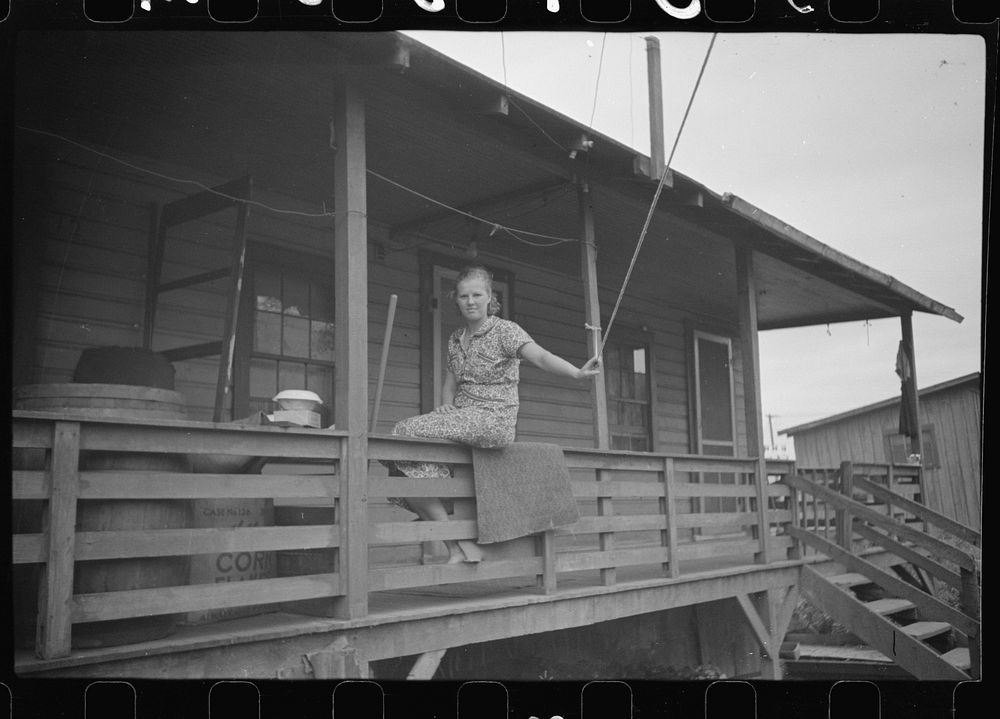 Coal miner's wife living in shacks by river. Scotts Run, West Virginia. Sourced from the Library of Congress.