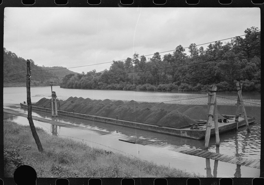 [Untitled photo, possibly related to: Coal barge on river, Scotts Run, West Virginia]. Sourced from the Library of Congress.