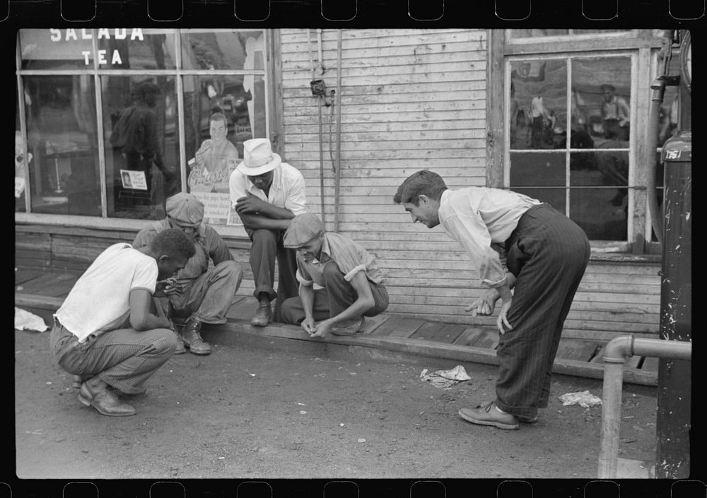 Shooting craps by company store, Osage, West Virginia. Sourced from the Library of Congress.