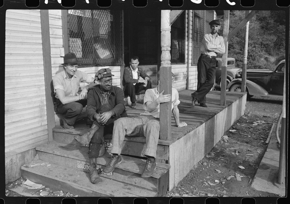 Coal miners on steps of company store, Scotts Run, West Virginia. Sourced from the Library of Congress.