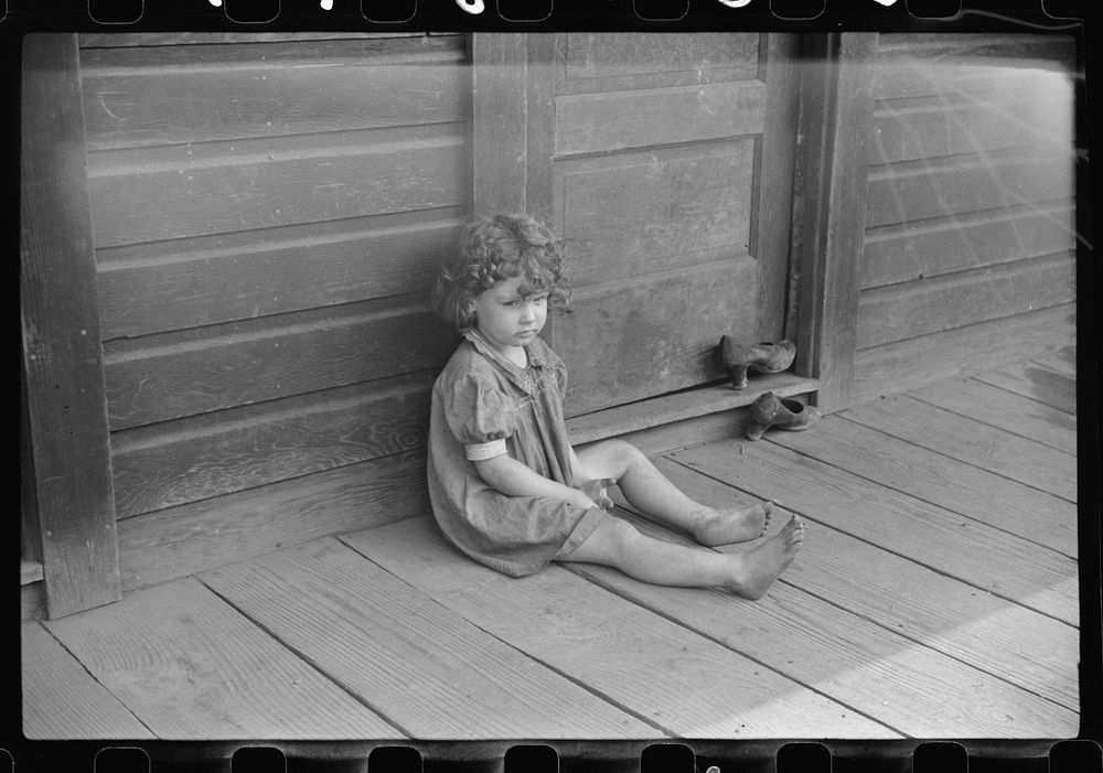 Miner's daughter on front porch, abandoned mining town, Jere, West Virginia. Sourced from the Library of Congress.