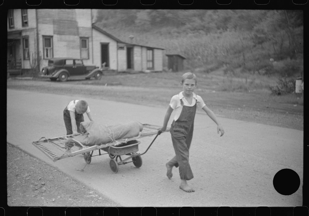 [Untitled photo, possibly related to: Children taking home remains of a bed. Coal mining camp, Scotts Run, West Virginia].…
