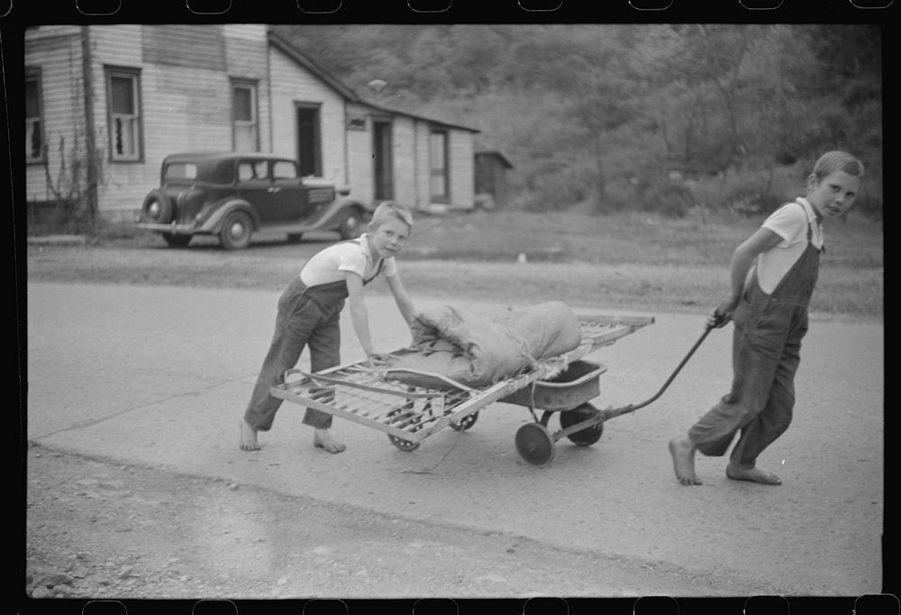 [Untitled photo, possibly related to: Children taking home remains of a bed. Coal mining camp, Scotts Run, West Virginia].…