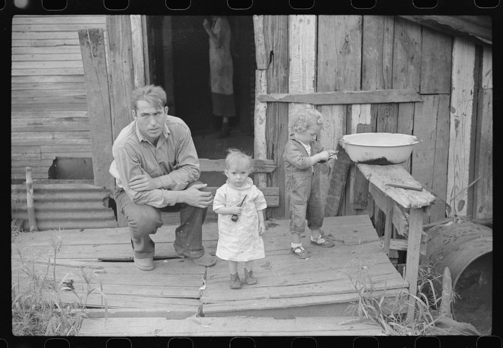 Coal miner and two of his children on their back porch. Bertha Hill, West Virginia. Sourced from the Library of Congress.