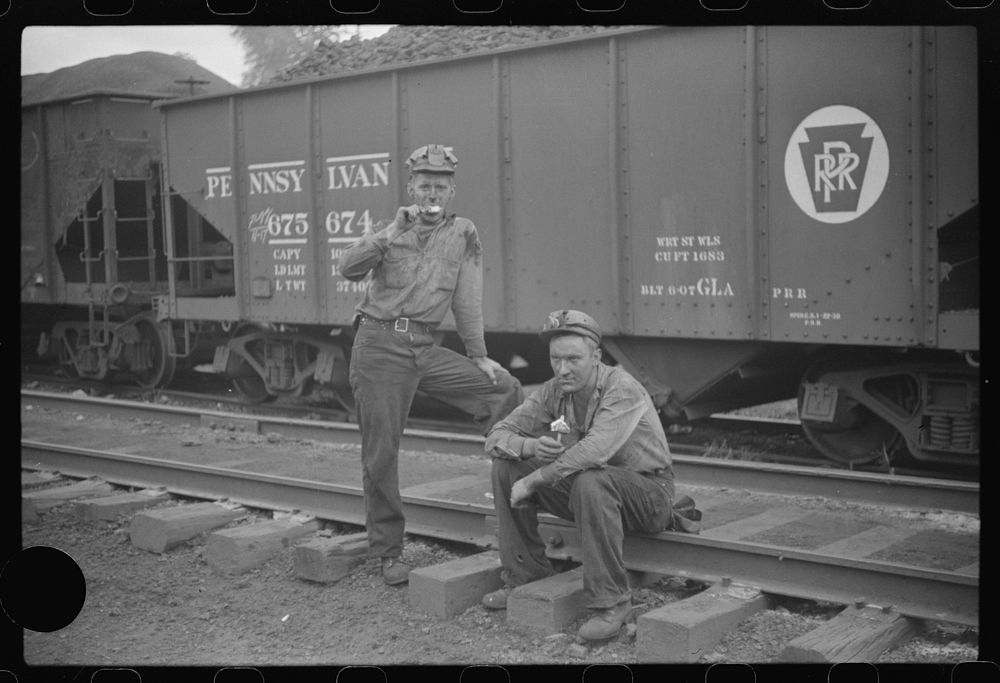 [Untitled photo, possibly related to: Coal miners waiting for the bus, eating ice cream suckers (popsicles). Pursglove, West…