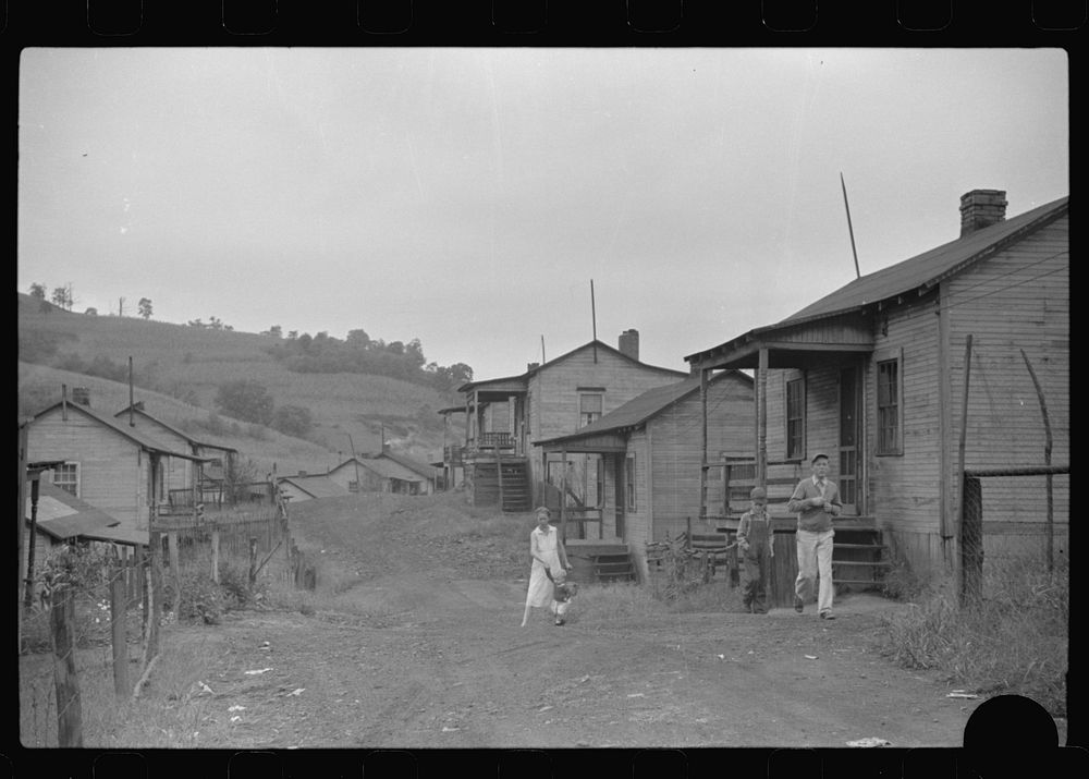 [Untitled photo, possibly related to: Coal miner's wife bringing home the groceries on payday from company store, Chaplin…