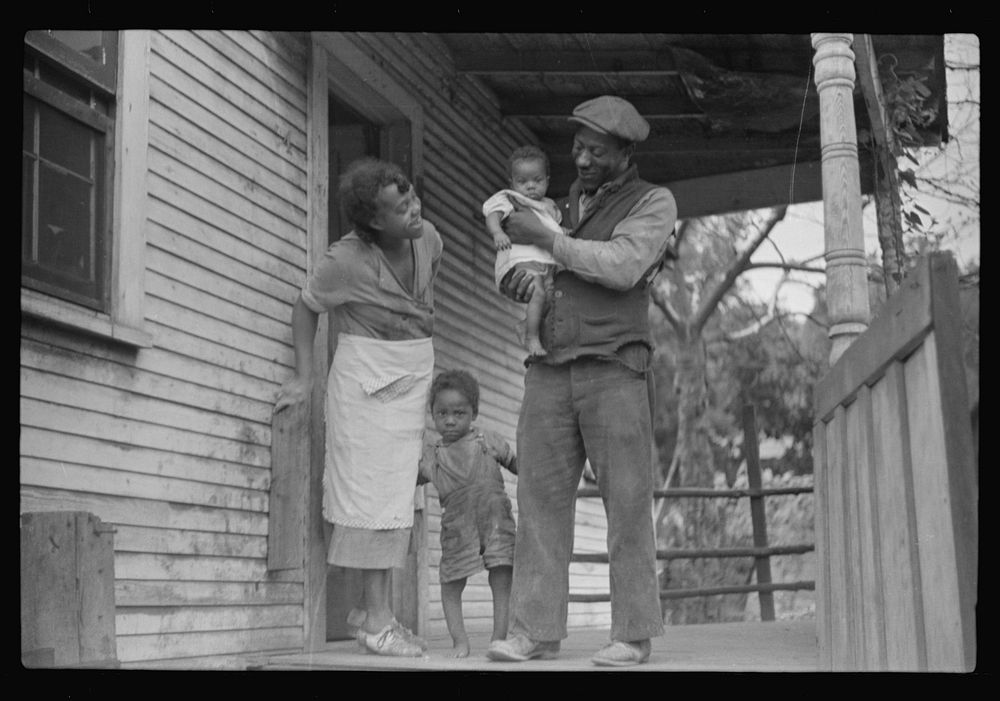 [Untitled photo, possibly related to: Coal miner, his wife and two of their children (note child's legs). Bertha Hill, West…