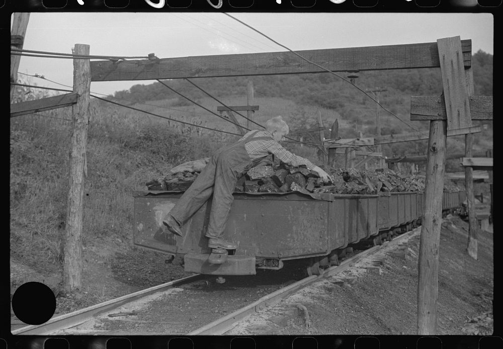 [Untitled photo, possibly related to: Coal miner's son swiping coal from coal cars for home use. The "Patch," Chaplin, West…