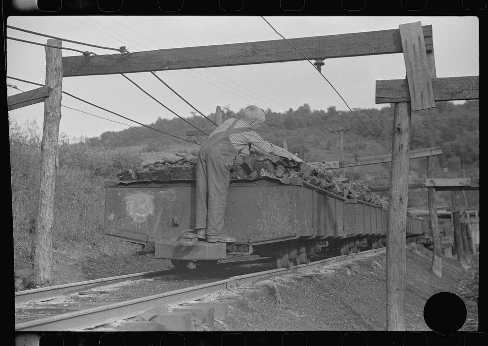 [Untitled photo, possibly related to: Coal miner's son swiping coal from coal cars for home use. The "Patch," Chaplin, West…