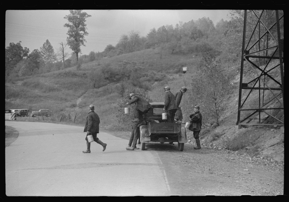 Coal miners coming to work in friend's truck; pay him for their rides. Maidsville, West Virginia. Sourced from the Library…