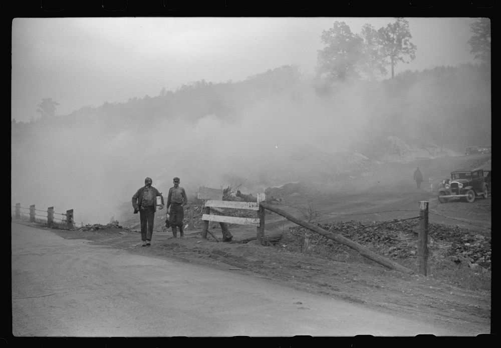 Coal miners coming from work. Slag heaps burning nearby. Maidsville, West Virginia. Sourced from the Library of Congress.
