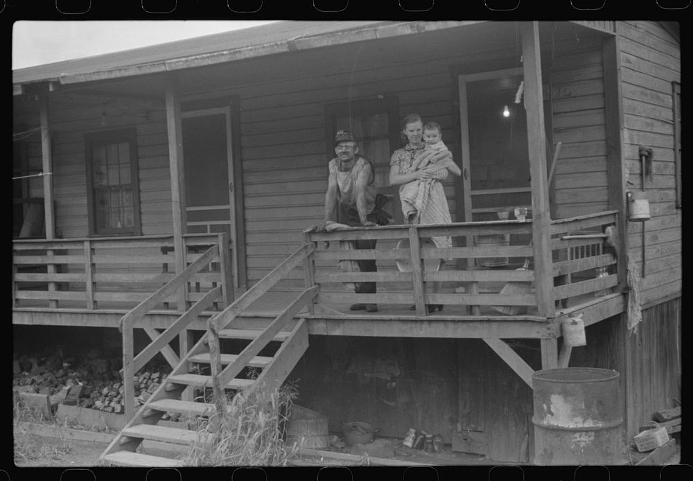 Coal miner, his wife and baby living in one of shanties seen in nos. 30144-M2 and 30151-M1. Scotts Run, West Virginia.…