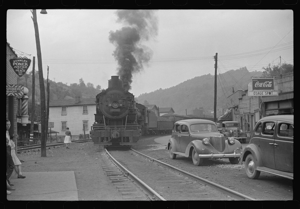 Train pulling coal through center of town morning and evening, Osage, West Virginia. Sourced from the Library of Congress.