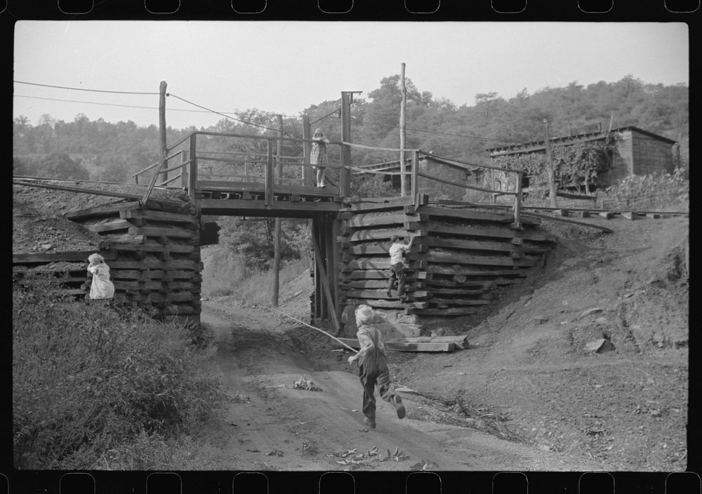Coal miner's children playing around tracks. Note live wires. Chaplin, West Virginia. Sourced from the Library of Congress.