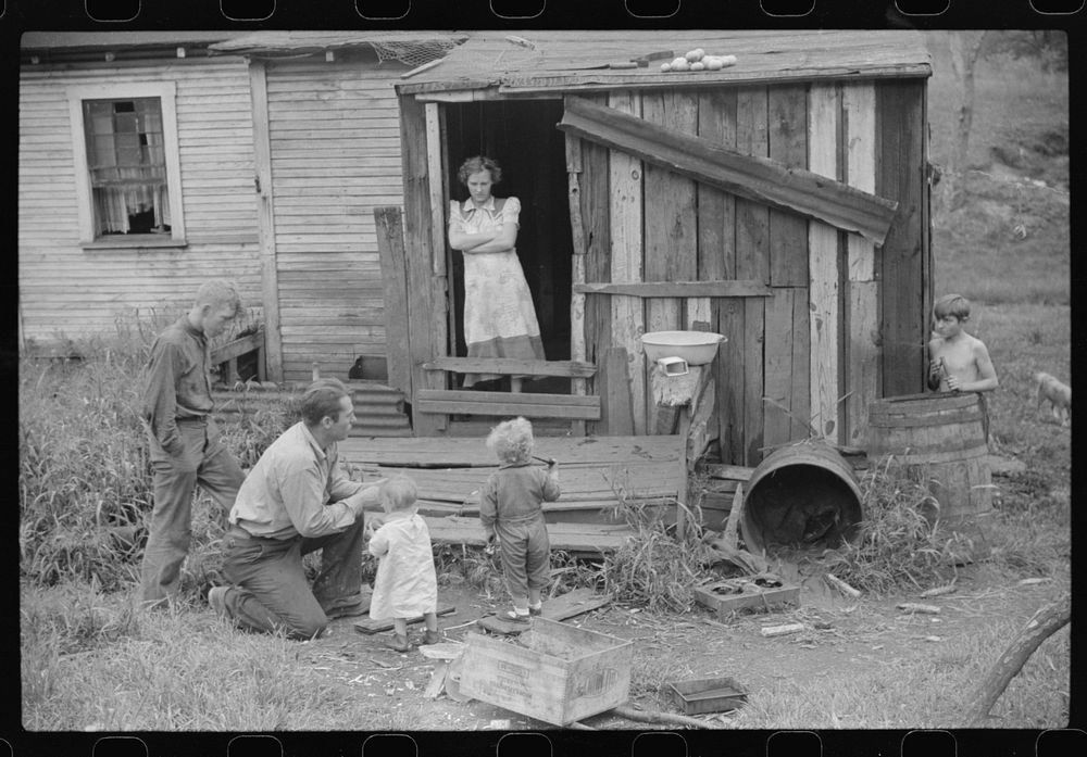 Coal miner and some of his family in back of their home. Bertha Hill, West Virginia. Sourced from the Library of Congress.