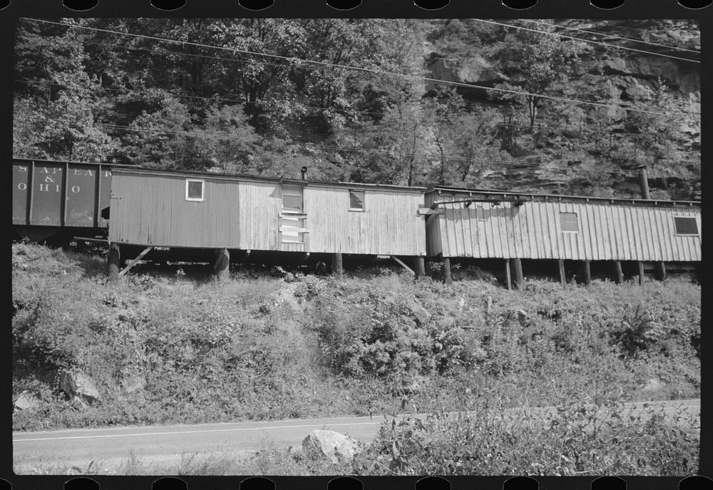 [Untitled photo, possibly related to: Old boxcars often converted into homes along highway between Charleston and Gauley…