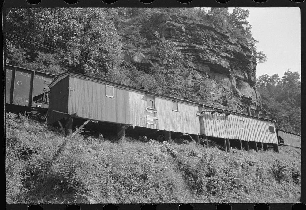 Old boxcars often converted into homes along highway between Charleston and Gauley Bridge, West Virginia. Sourced from the…