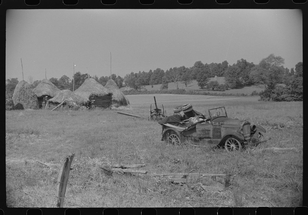 Old broken-down car and farm machinery in middle of farmer's field, West Virginia. Sourced from the Library of Congress.