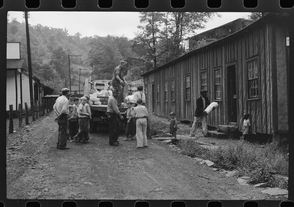 The relief truck brings food supplies to abandoned mining town, Jere, West Virginia. The shack on right is used as community…