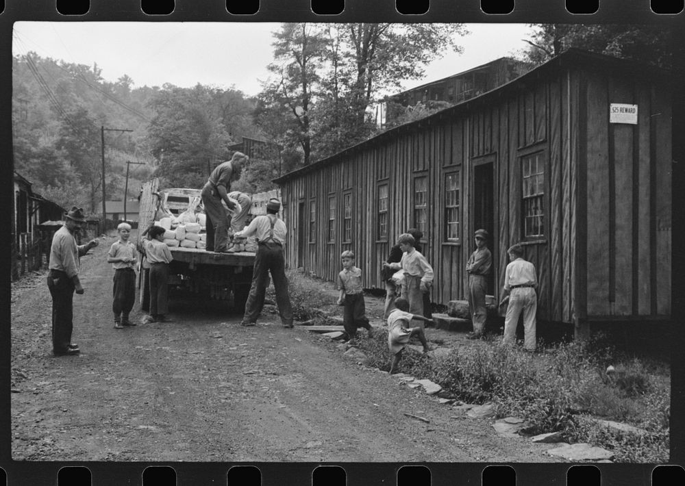 [Untitled photo, possibly related to: The relief truck brings food supplies to abandoned mining town, Jere, West Virginia.…
