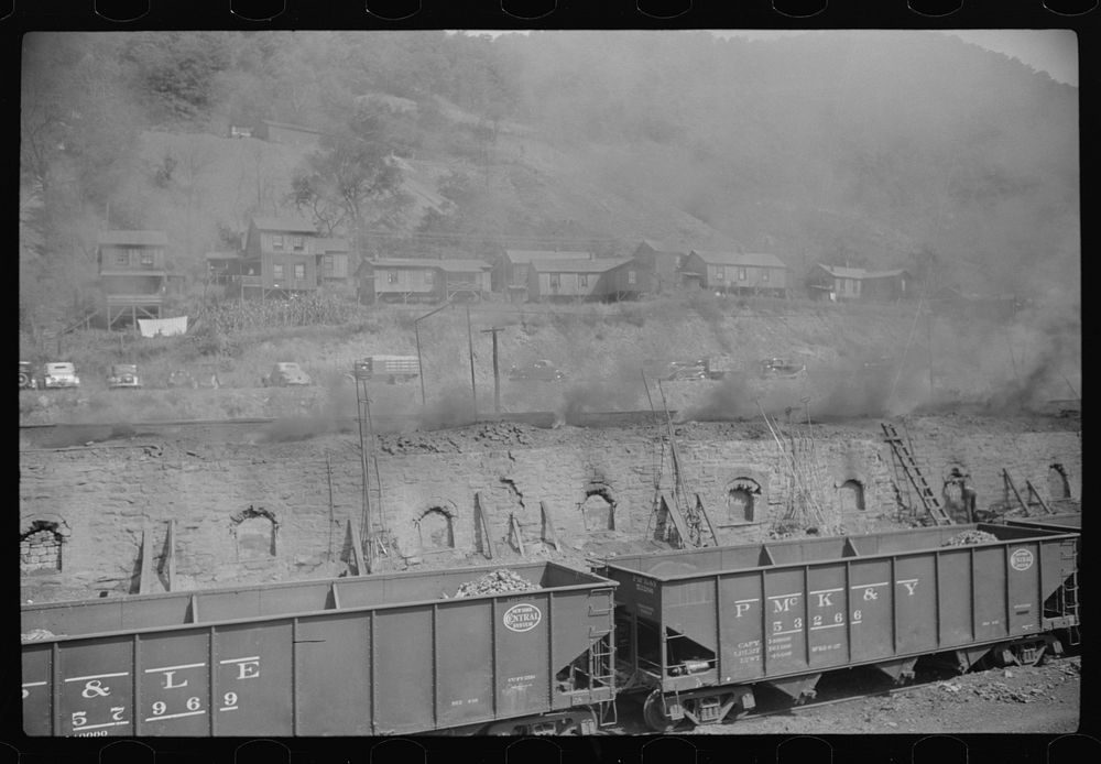 Coke ovens make heavy impenetrable smoke over whole town. Workers' homes in background. Longacre, West Virginia. Sourced…