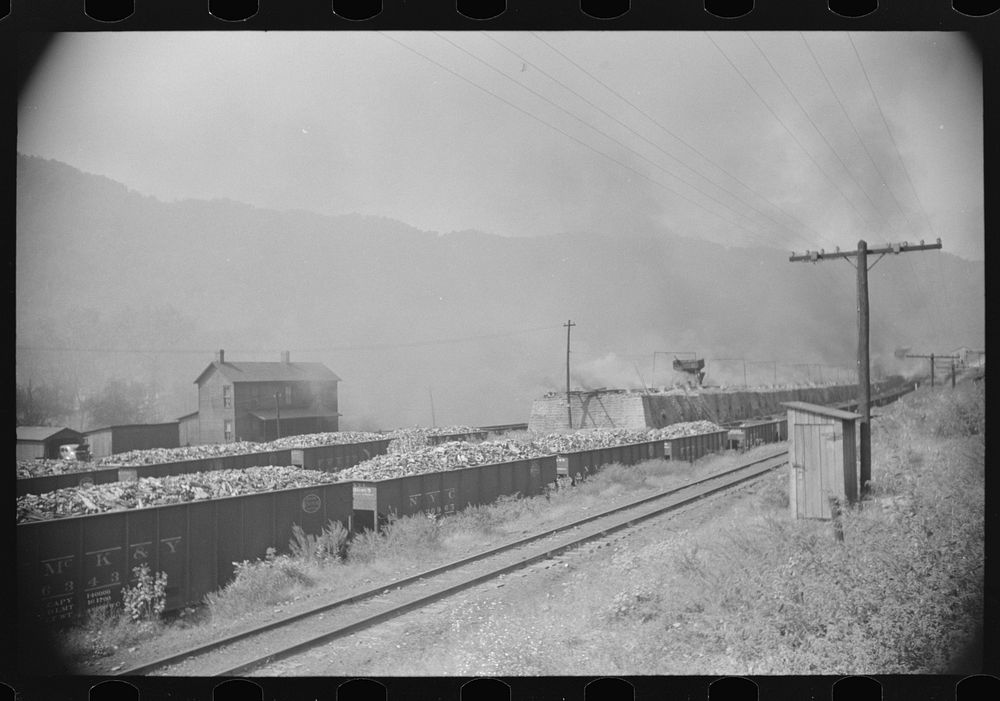 Coke ovens and burning slag heaps make heavy impenetrable smoke over whole town, day and night. Longacre, West Virginia.…