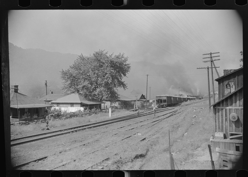 [Untitled photo, possibly related to: Coke ovens and burning slag heaps make heavy impenetrable smoke over whole town, day…
